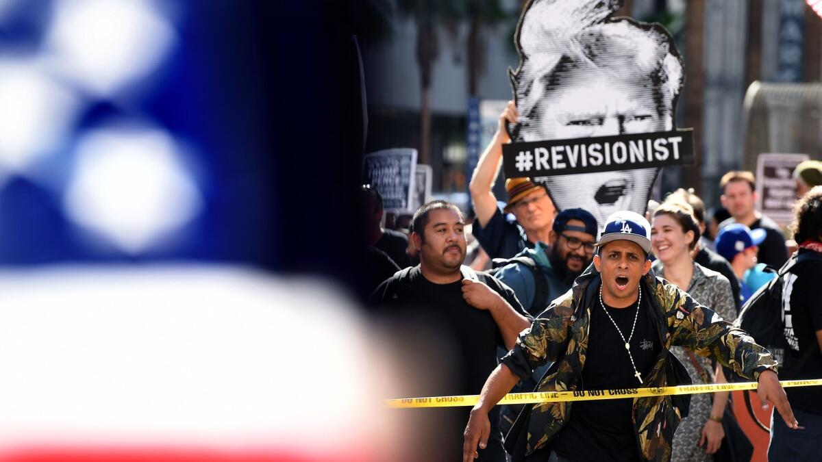 An anti-Trump protester yells at Trump supporters during a demonstration in downtown Los Angeles in November 2017.