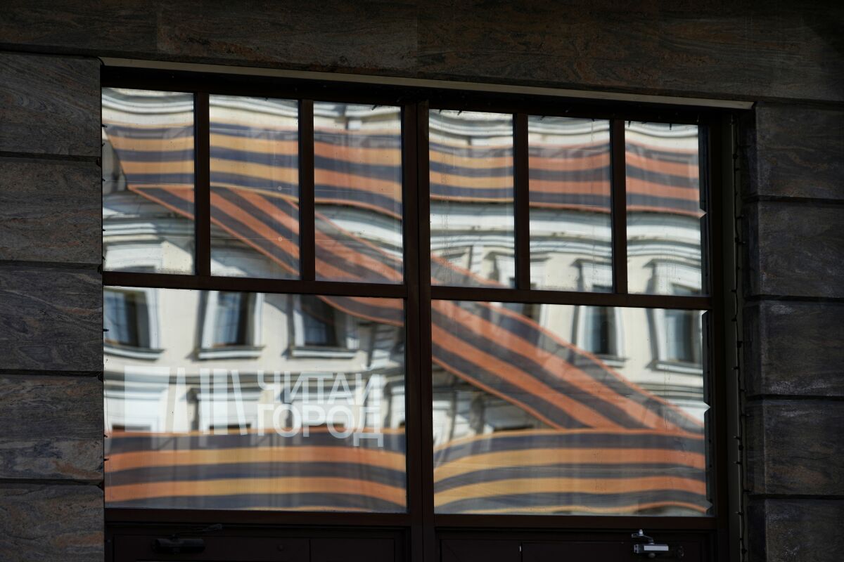A huge letter Z, which has become a symbol of the Russian military, is reflected in an office building in a street in Moscow, Russia, Friday, May 6, 2022. Red Soviet flags and orange-and-black striped military ribbons are on display in Russian cities and towns. Neighborhoods are staging holiday concerts. Flowers are being laid by veterans' groups at monuments to the Great Patriotic War, as World War II is known in the country. At first glance, preparations for Monday's celebration of Victory Day, marking the defeat of Nazi Germany in 1945, seem to be the same as ever. But the mood this year is very different, because Russian troops are fighting and dying again. (AP Photo/Alexander Zemlianichenko)