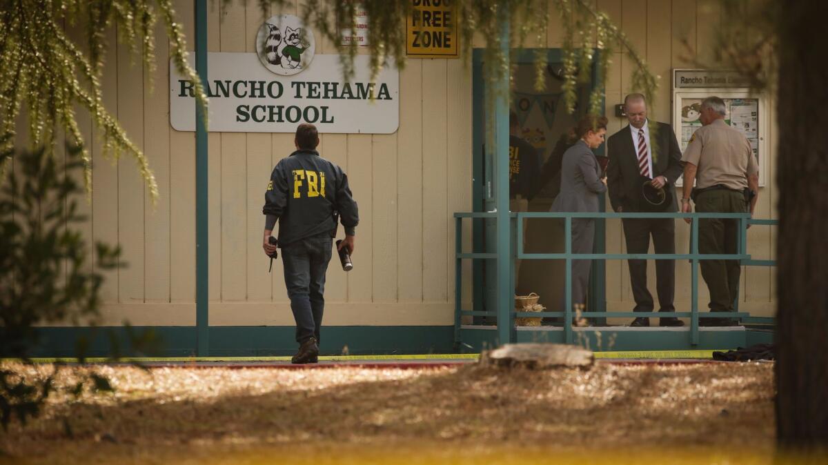 FBI agents are seen behind yellow crime scene tape outside Rancho Tehama Elementary School on Tuesday.