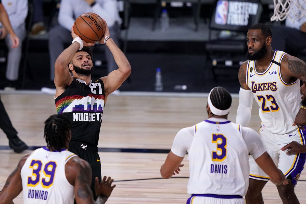Nuggets guard Jamal Murray pulls up for a jumper among a group of Lakers defenders during Game 3.