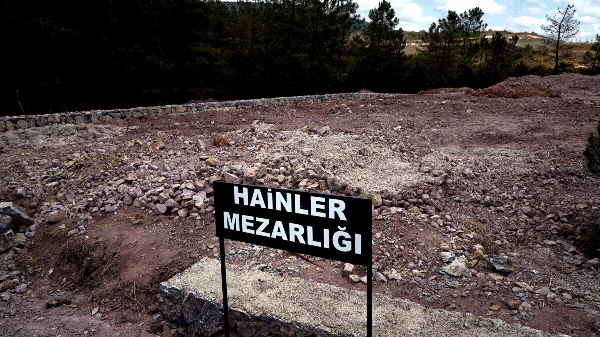 A sign reading "Traitors' Cemetery" in Turkish is seen in front of unmarked graves, built specifically to hold the bodies of coup plotters who died in the failed military coup, in eastern Istanbul, Turkey.