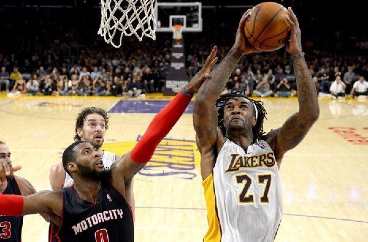 Lakers power forward Jordan Hill (27) tries to score inside against Pistons center Andre Drummond during a game at Staples Center.