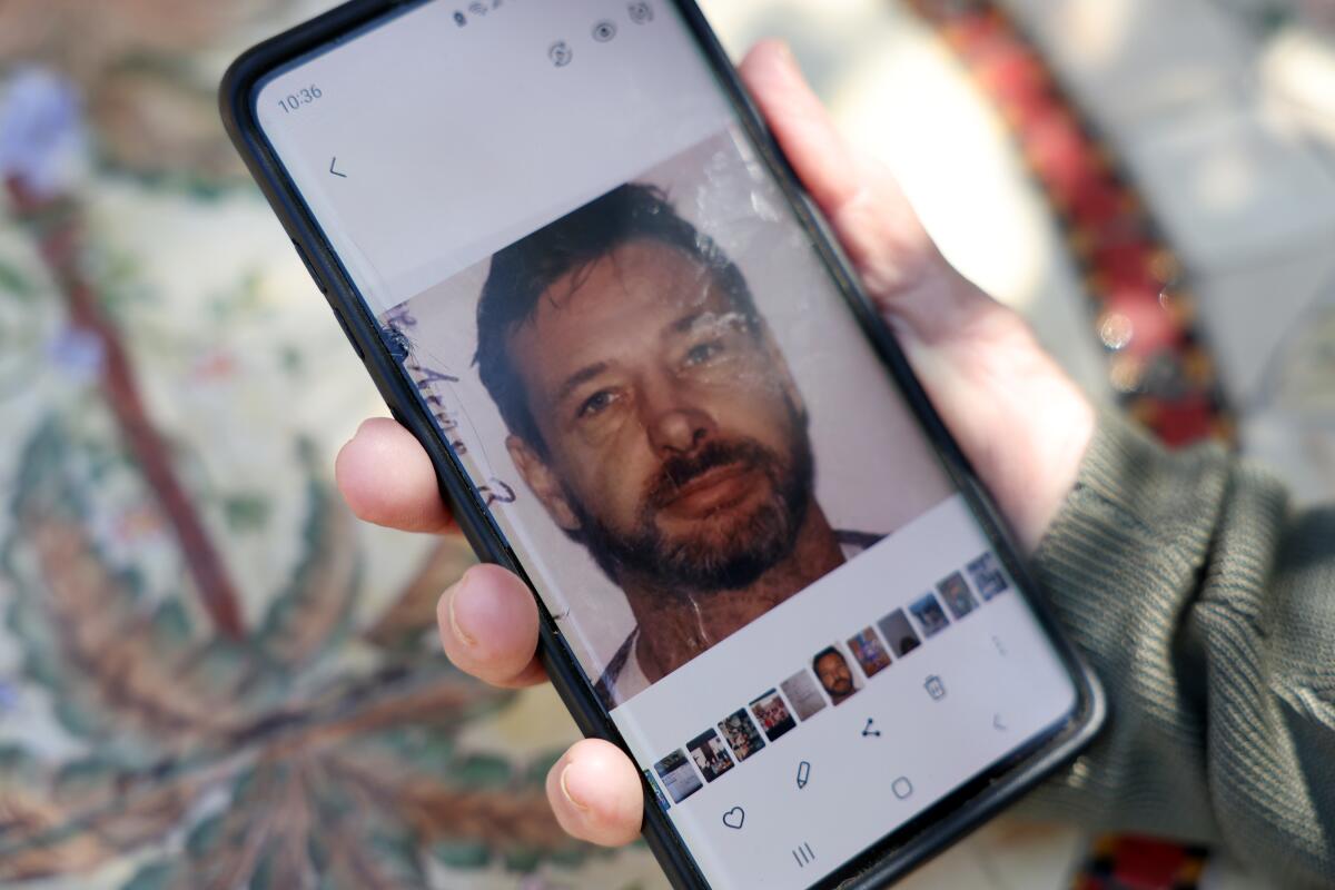 SaraLynn Mandel holds a photograph of Inge Baumbach