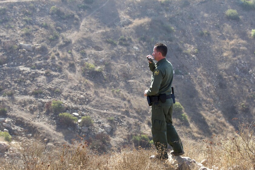US Border Patrol Agent looked off in to the Otay Mountain Wilderness Area