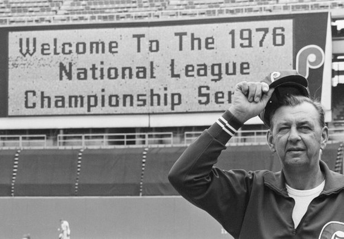 Manager Danny Ozark tips his cap as the Veterans Stadium scoreboard flashes a test sign before the 1976 National League Championship Series between his Philadelphia Phillies and the Cincinnati Reds.