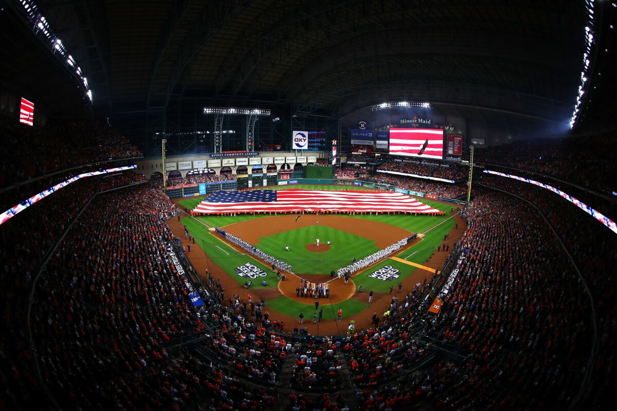 A giant American flag is held on the field as the national anthem is performed at Minute Maid Park.