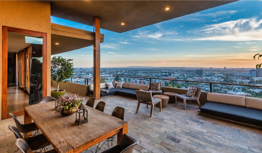 The hillside home includes three levels of decks, balconies and patios, as well as a swimming pool and spa.