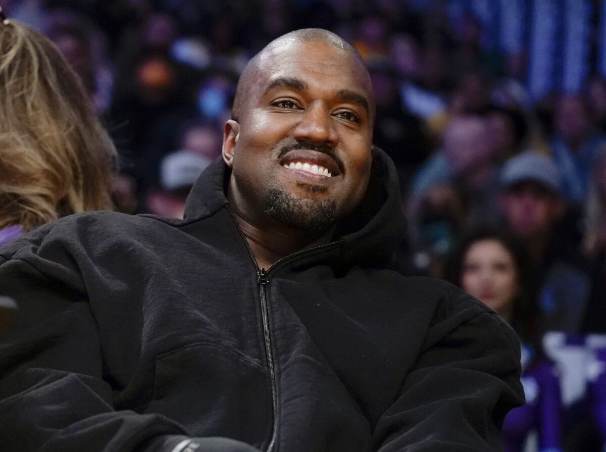 FILE - Kanye West, known as Ye, watches the first half of an NBA basketball game between the Washington Wizards and the Los Angeles Lakers in Los Angeles, on March 11, 2022. A senior Australian government minister said Wednesday, Jan. 25, 2023, that Ye, could be refused a visa due to antisemitic comments if he attempts to visit Australia. (AP Photo/Ashley Landis, File)