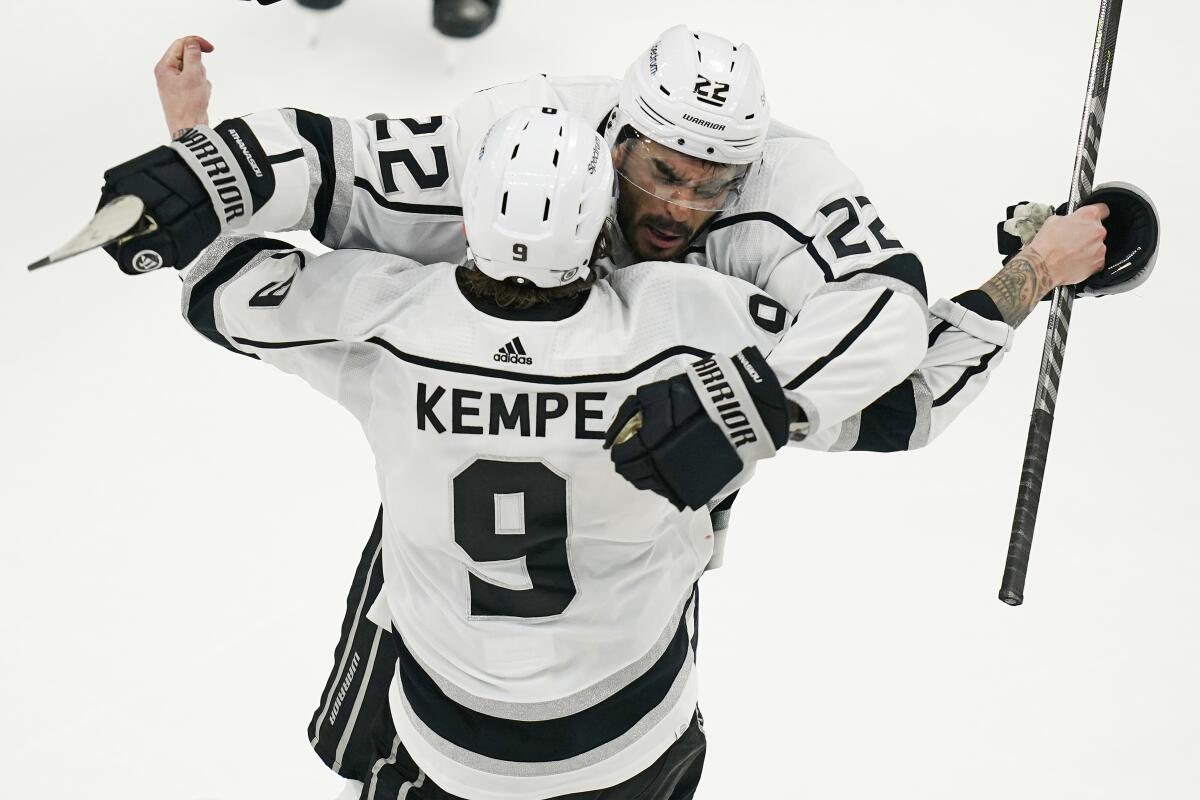 Kings center Andreas Athanasiou is congratulated by Adrian Kempe after scoring a game-winning goal Monday.