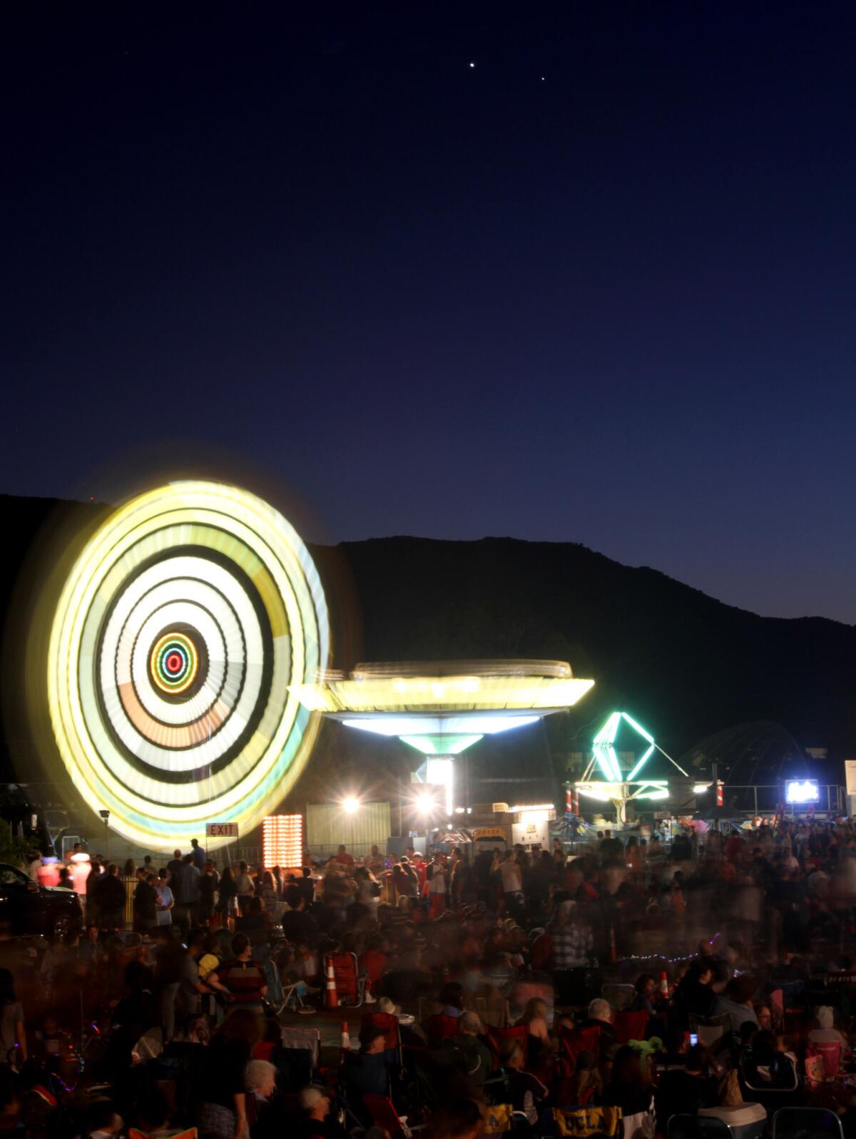 A large crowd enjoyed rides and a front row view of Venus and Jupiter in the sky above the Crescenta Valley Fireworks Assn.'s Annual Fourth of July carnival and fireworks display at La Crescenta Elementary on Saturday, July 4, 2015.