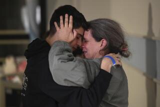 This handout photo provided by Haim Zach/GPO shows Sharon Hertzman, right, hugging a relative as they reunite at Sheba Medical Center in Ramat Gan, Israel, Saturday Nov. 25, 2023. Sharon Hertzman and her daughter Noam, 12 years old, not pictured, were released by Hamas after being held as hostages in Gaza for 50 days. (Haim Zach/GPO/Handout via AP)