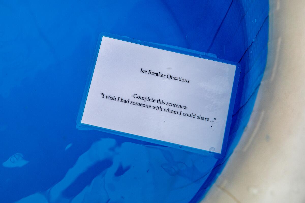 A laminated sheet of paper with "Icebreaker questions" in a blue pool