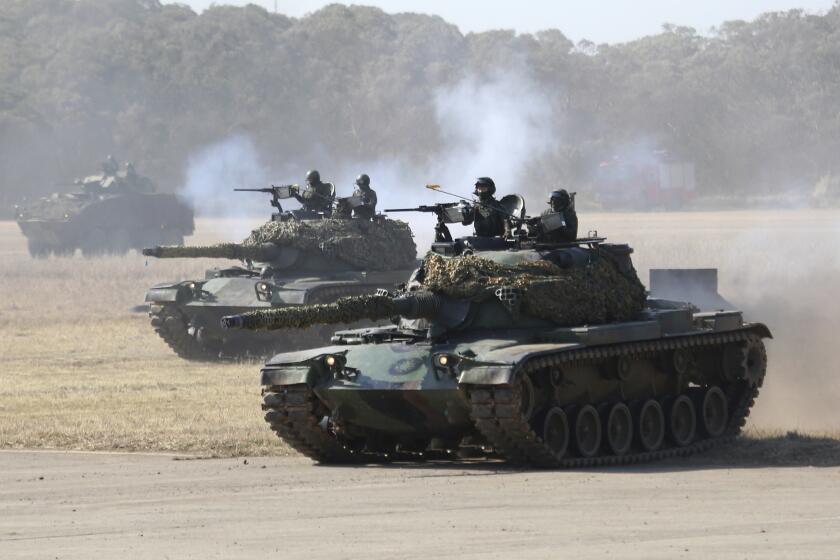 A line of Taiwan's tanks move during a military exercise in Hsinchu County, northern Taiwan, Tuesday, Jan. 19, 2021. (AP Photo/Chiang Ying-ying)