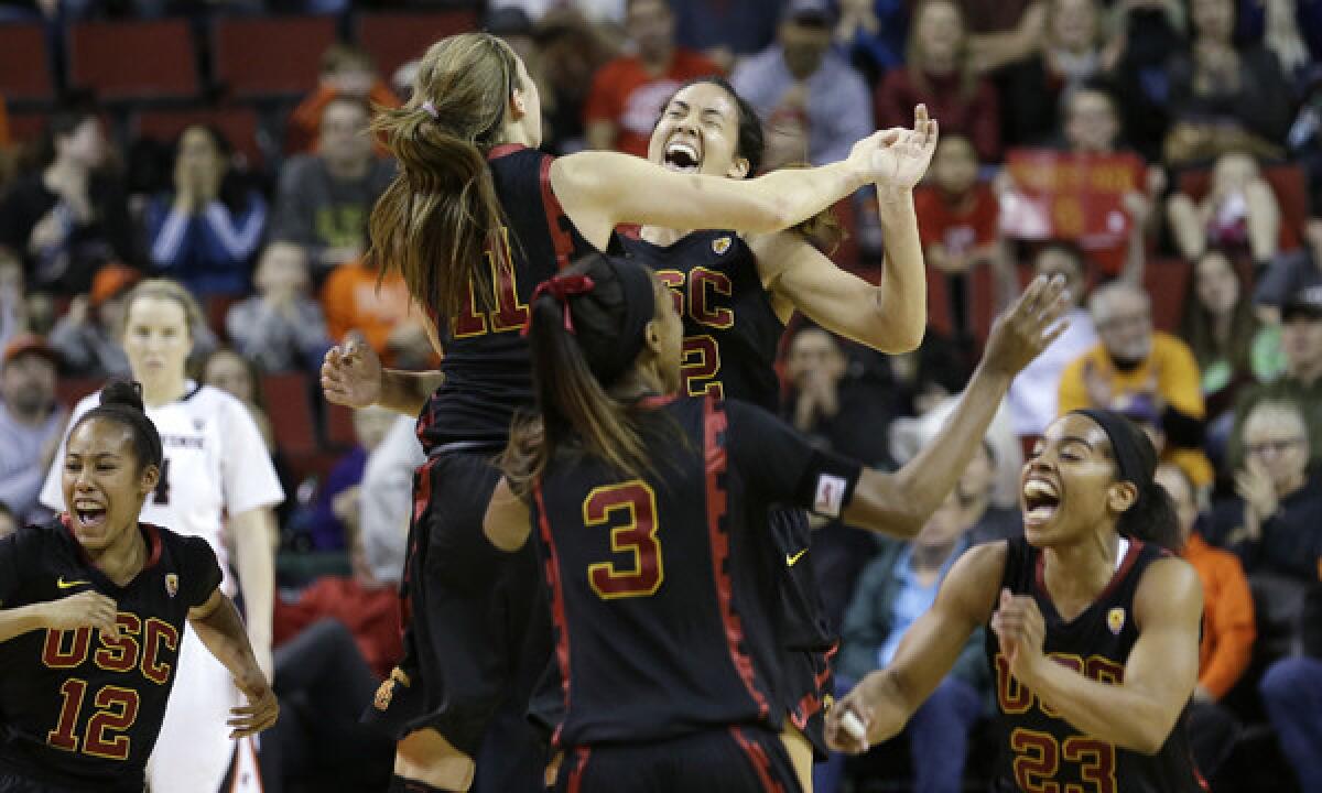 USC players celebrate their 71-62 win over Oregon State in the Pac-12 tournament title game on Sunday.