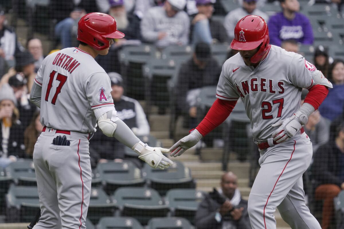 Los Angeles Angels' Mike Trout, right, celebrates with Shohei Ohtani, of Japan, after hitting a solo home run during the first inning of a baseball game against the Chicago White Sox in Chicago, Sunday, May 1, 2022. (AP Photo/Nam Y. Huh)