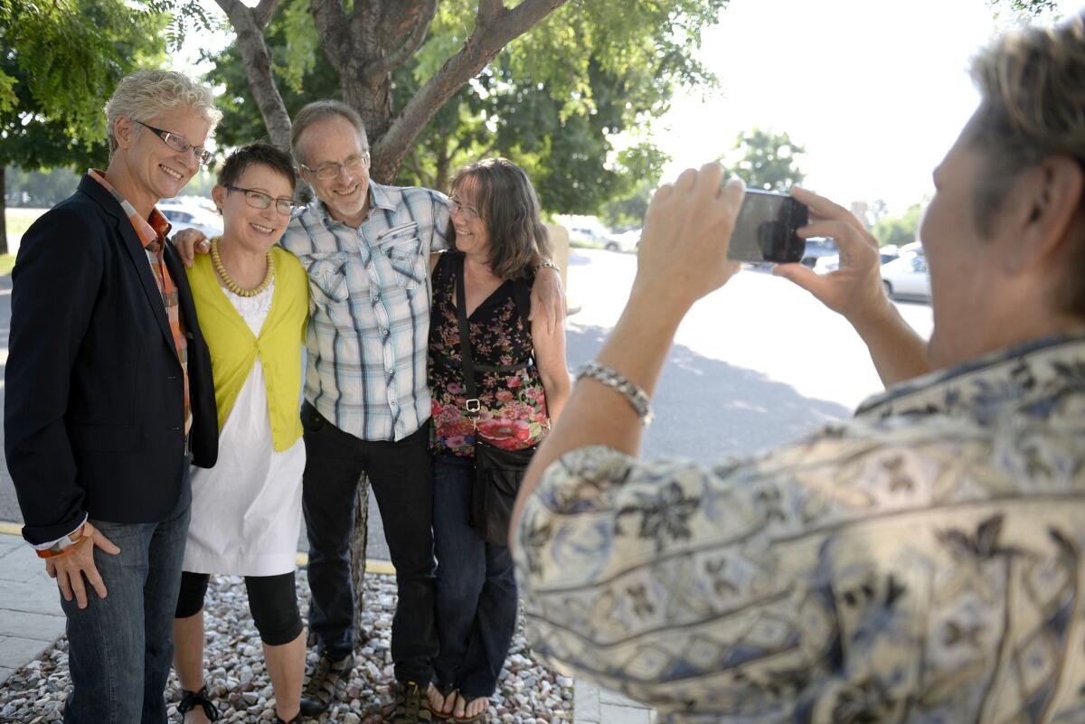 Julie Hoehing, from left, and Nancy Cooley, pose with Cooley's brother, Joe Walsh, and Jeanne Walsh while Ann Noonen takes a photo before Hoehnig and Cooley got married at the Boulder County Clerk and Recorder's Office in Colorado on July 1.