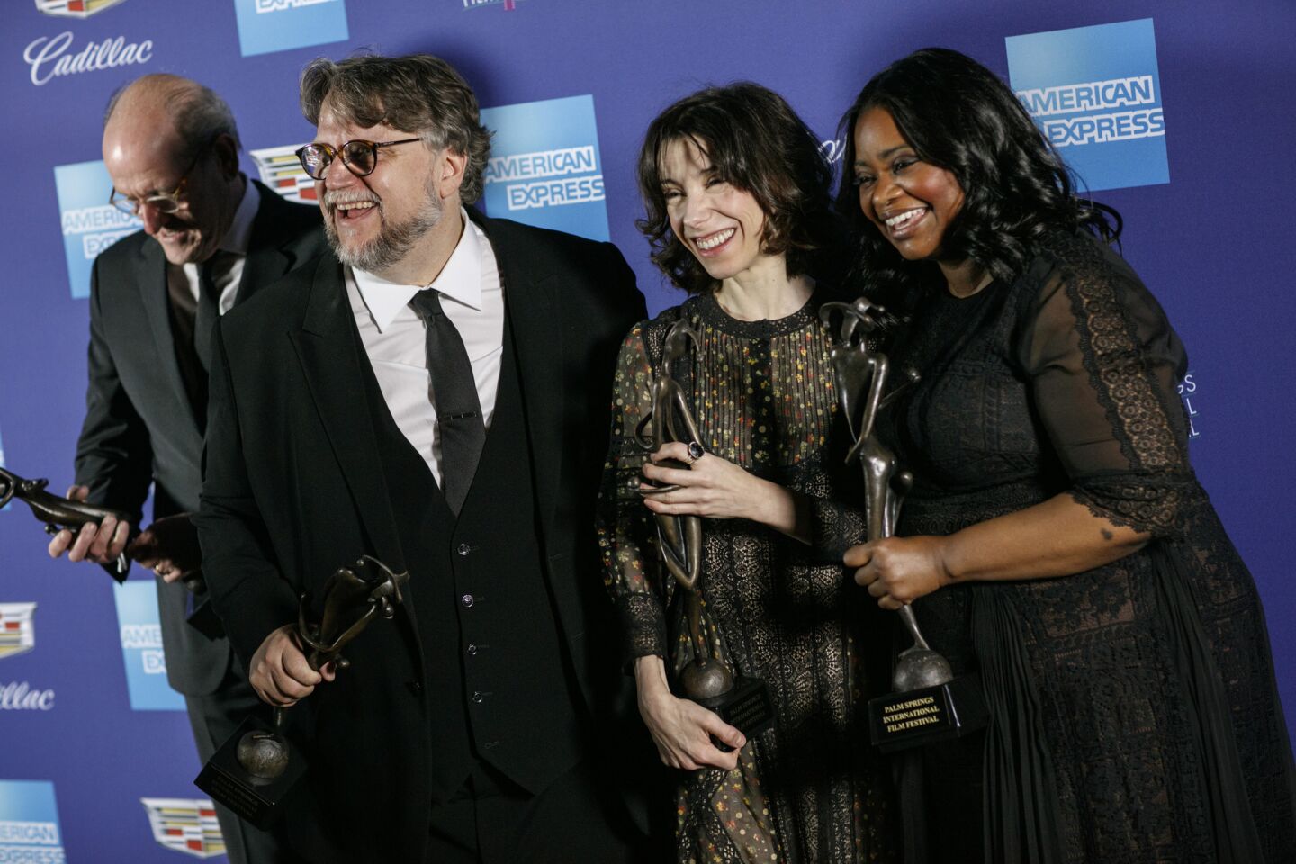 "The Shape of Water" director Guillermo del Toro, second from left, laughs with his cast, Richard Jenkins, Sally Hawkins and Octavia Spencer, backstage with their Vanguard Award at the Palm Springs International Film Festival Gala.