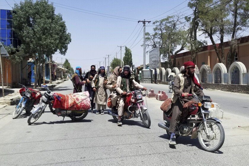 Taliban fighters on motorcycles patrol inside the city of Ghazni, Afghanistan.