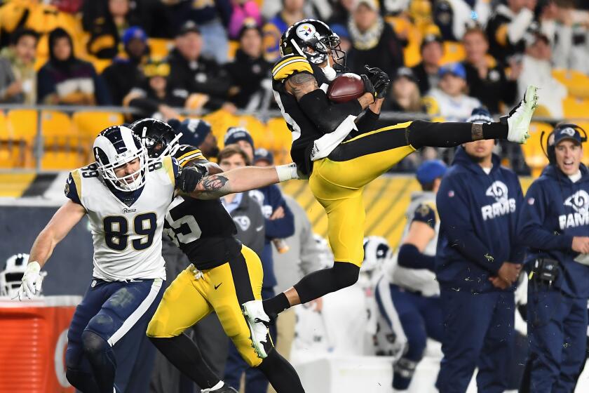 PITTSBURGH, PENNSYLVANIA NOVEMBER 10, 2019-Steelers cornerback Joe Haden intercepts a pass intended for Rams tight end Tyler Higbee in the 3rd quarter at Heinz Field in Pittsburgh Sunday. (Wally Skalij/Los Angerles Times)