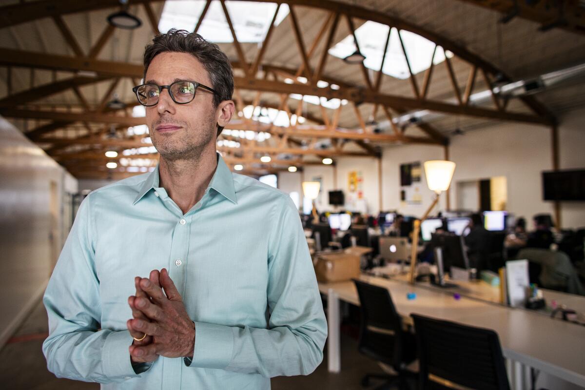 A man inside a hangar-like building.