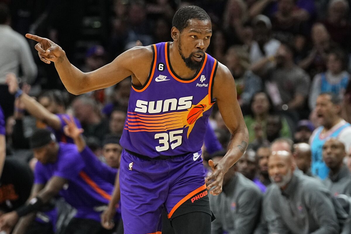 Phoenix Suns forward Kevin Durant (35) motions after making a basket against the Denver Nuggets during the first half of an NBA basketball game, Friday, March 31, 2023, in Phoenix. (AP Photo/Matt York)
