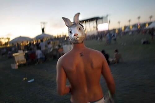 Follow the white hare? A man wearing a rabbit mask on the back of his head makes his way to the main stage at Coachella.