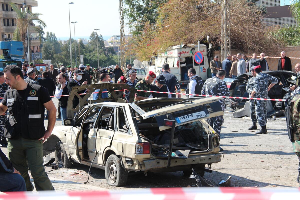 Authorities cordon off the site of a suicide car bomb attack in a crowded Beirut suburb.