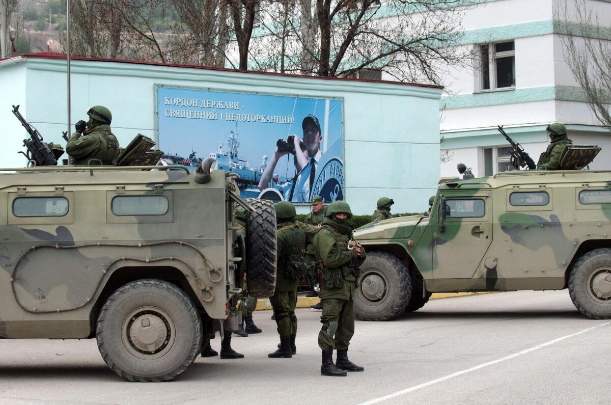 Unidentified armed individuals with armored vehicles block the base of the Ukrainian border guard service in Sevastopol over the weekend.