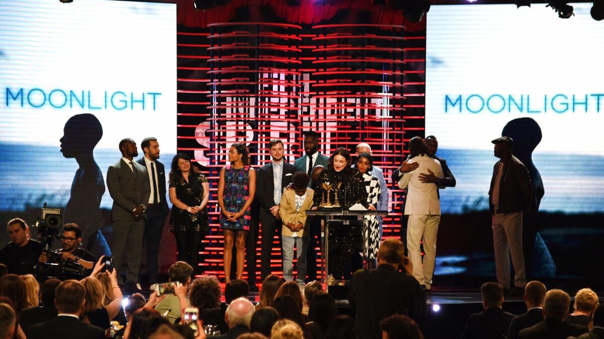 Producer Adele Romanski (center) speaks as she and the cast and crew of "Moonlight" accept the feature award at the 2017 Film Independent Spirit Awards at the Santa Monica Pier on Feb. 25.