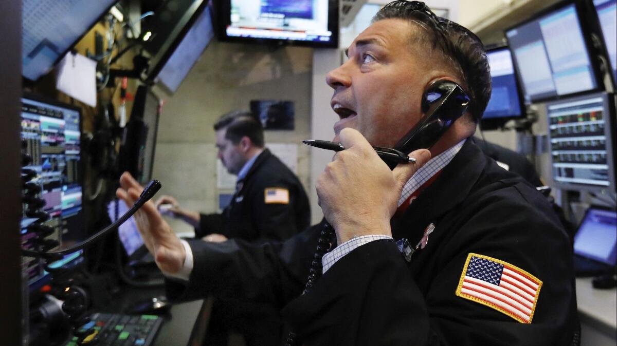 Trader Jonathan Mueller works in a booth on the floor of the New York Stock Exchange on Dec. 7.