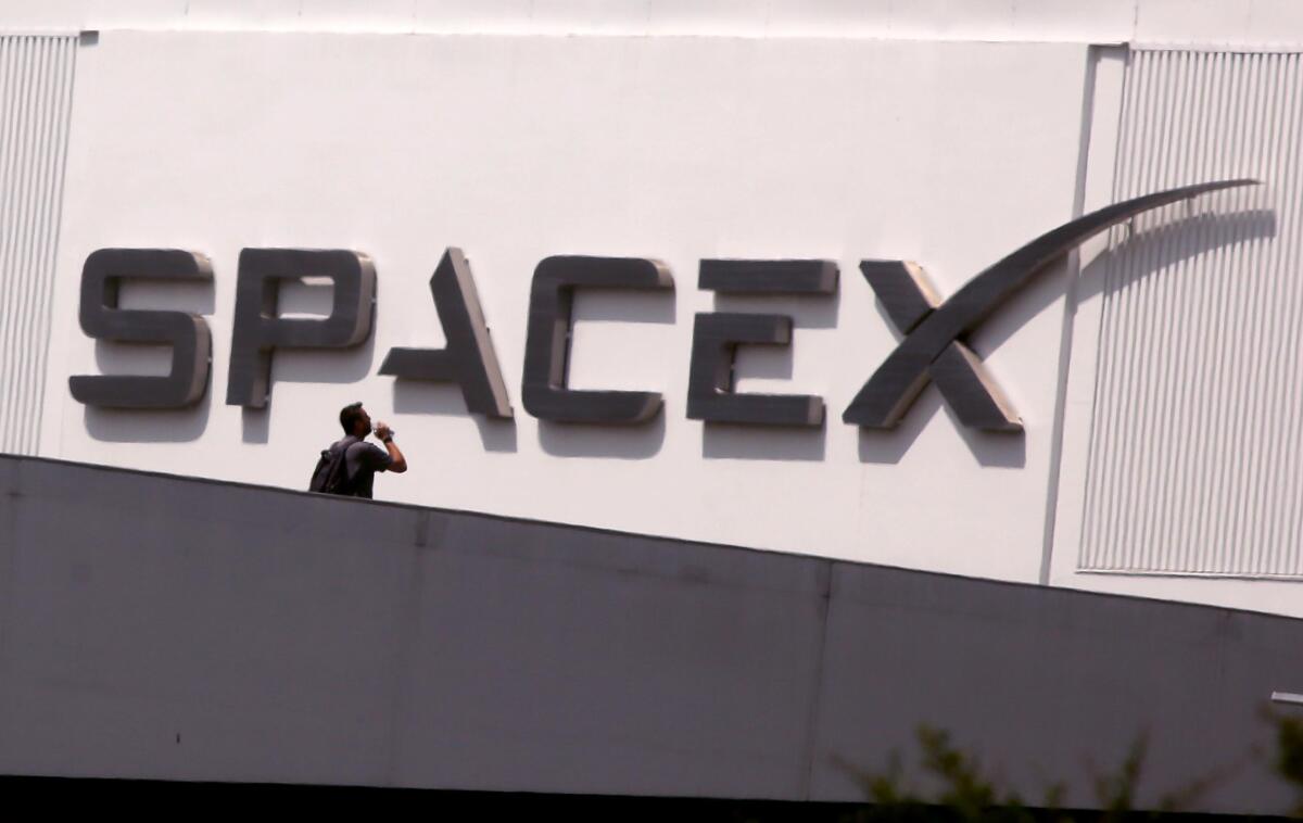 An employee walks across the bridge from parking to SpaceX in Hawthorne.