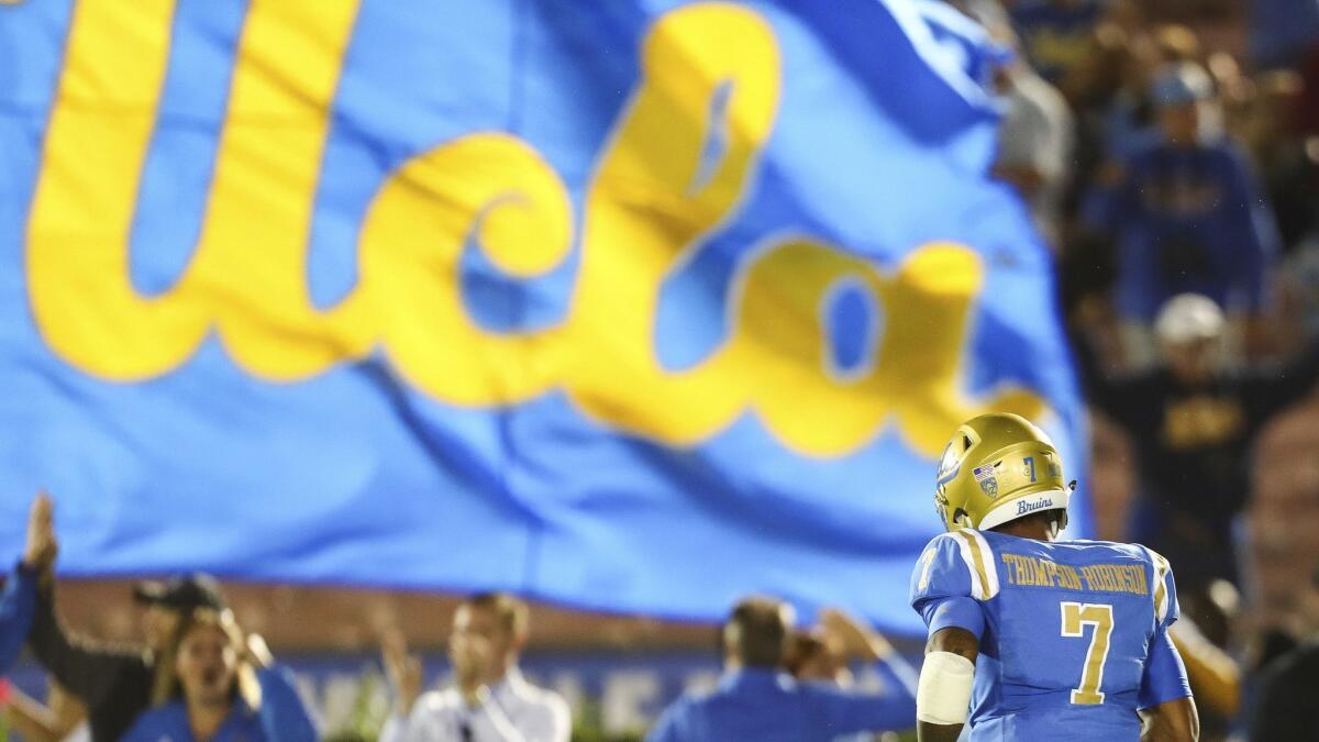 UCLA Bruins quarterback Dorian Thompson-Robinson runs off the field during a game against Washington in October.