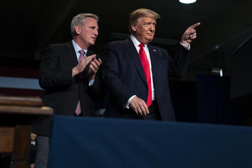 House Minority Leader Kevin McCarthy of Calif., talks with President Donald Trump during an event on California water accessibility, Wednesday, Feb. 19, 2020, in Bakersfield, Calif. (AP Photo/Evan Vucci)