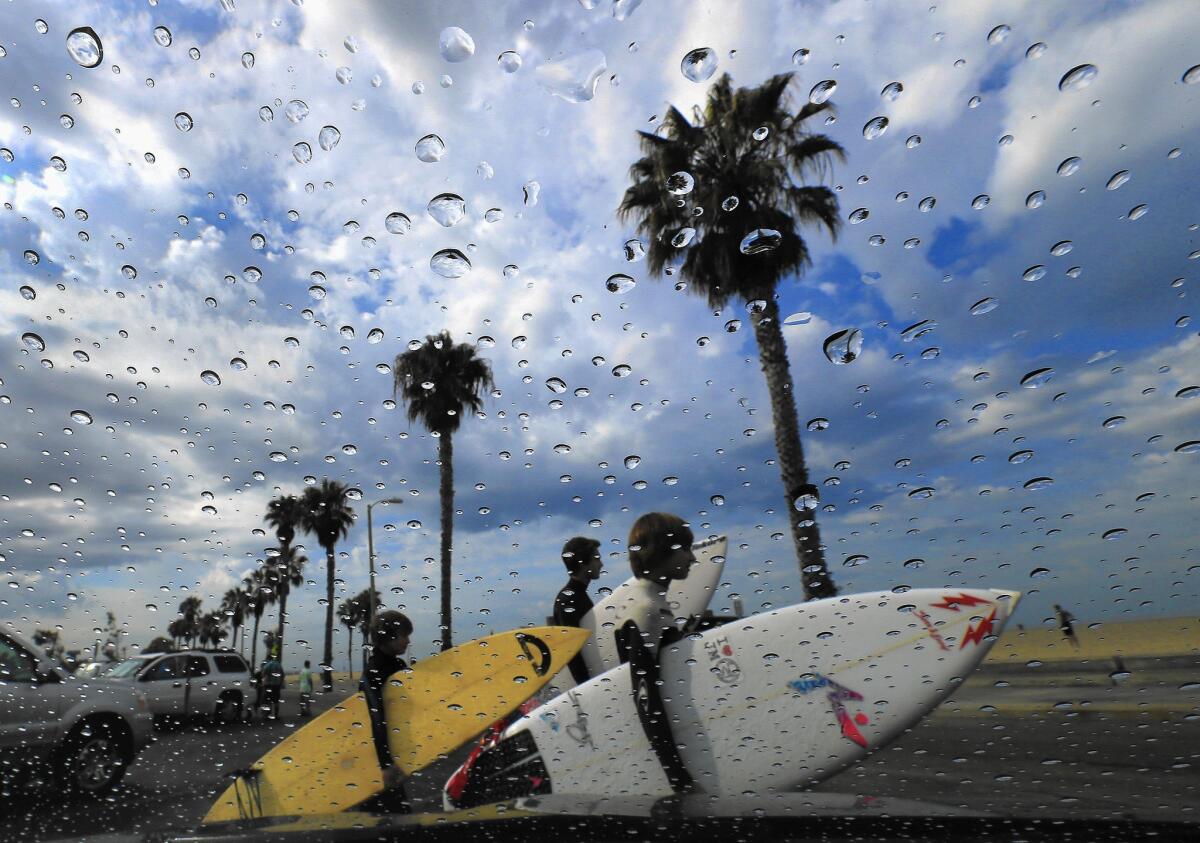 Rain gathers on a windshield and storm clouds roll in as surfers head out to the beach July 18. The surfers ended up turning around and heading home after they were advised by Los Angeles County Fire Department lifeguards that all Los Angeles County beaches were closed.