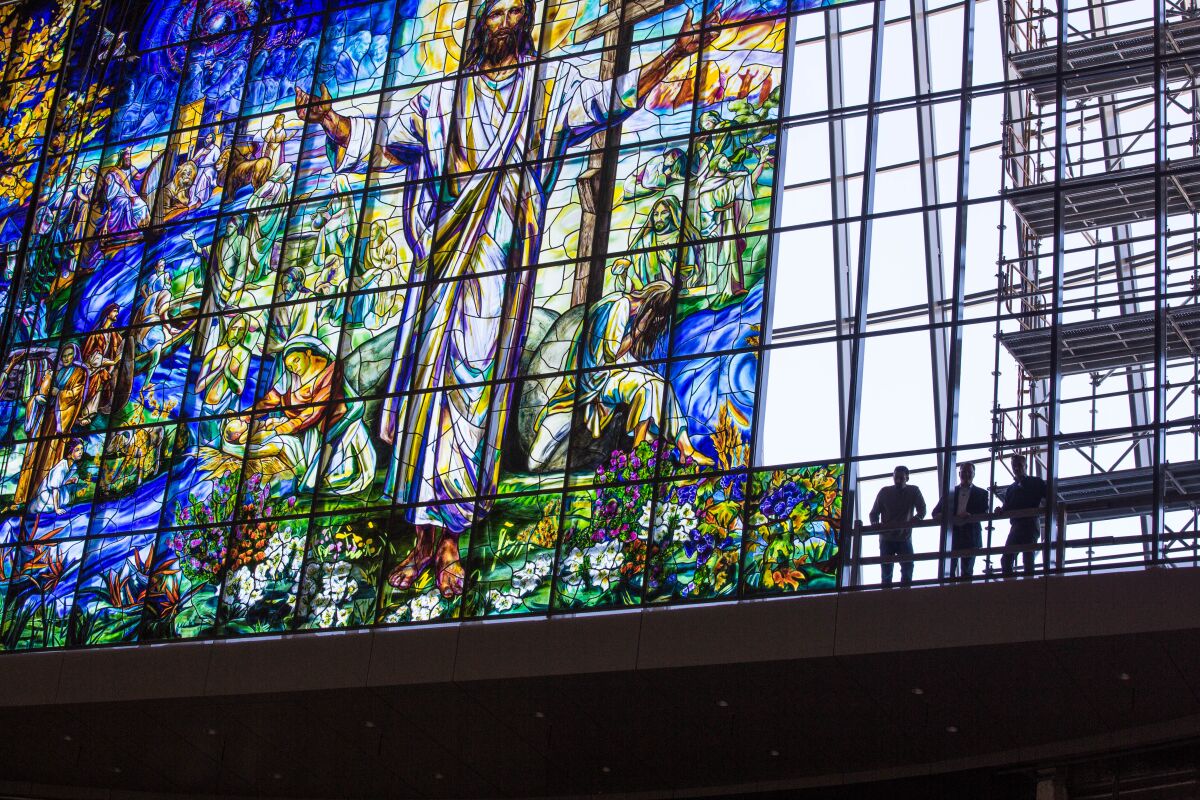Workers reveal the scale of the monumental Judson Studios window at the Church of the Resurrection in Leawood, Kan., featured in the new book "Judson: Innovation in Stained Glass."