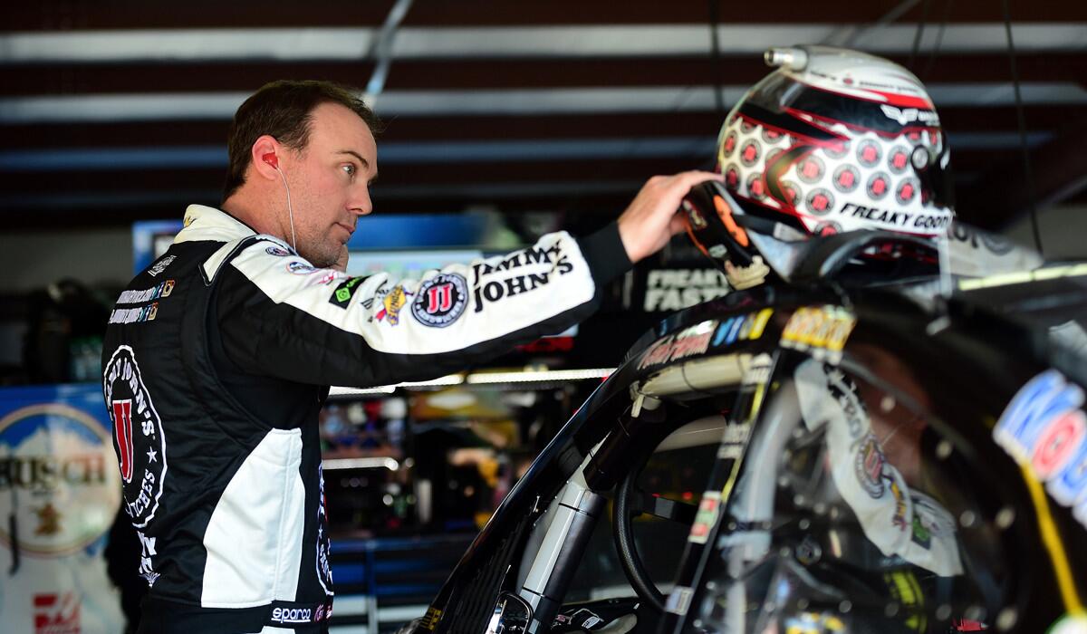 Kevin Harvick stands in the garage area during practice for the NASCAR Sprint Cup Series Hellmann's 500 at Talladega Superspeedway on Oct. 21.