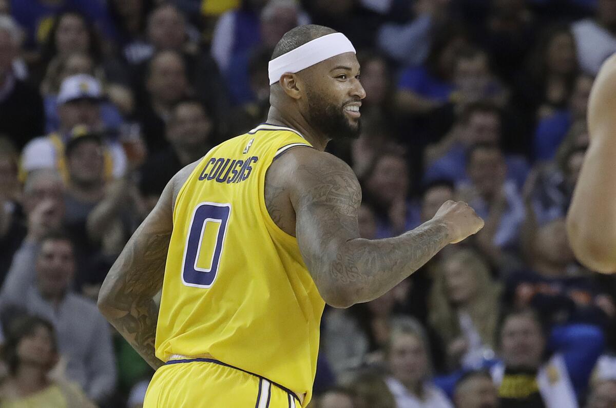 Golden State's DeMarcus Cousins smiles after scoring against the Denver Nuggets on April 2 in Oakland.