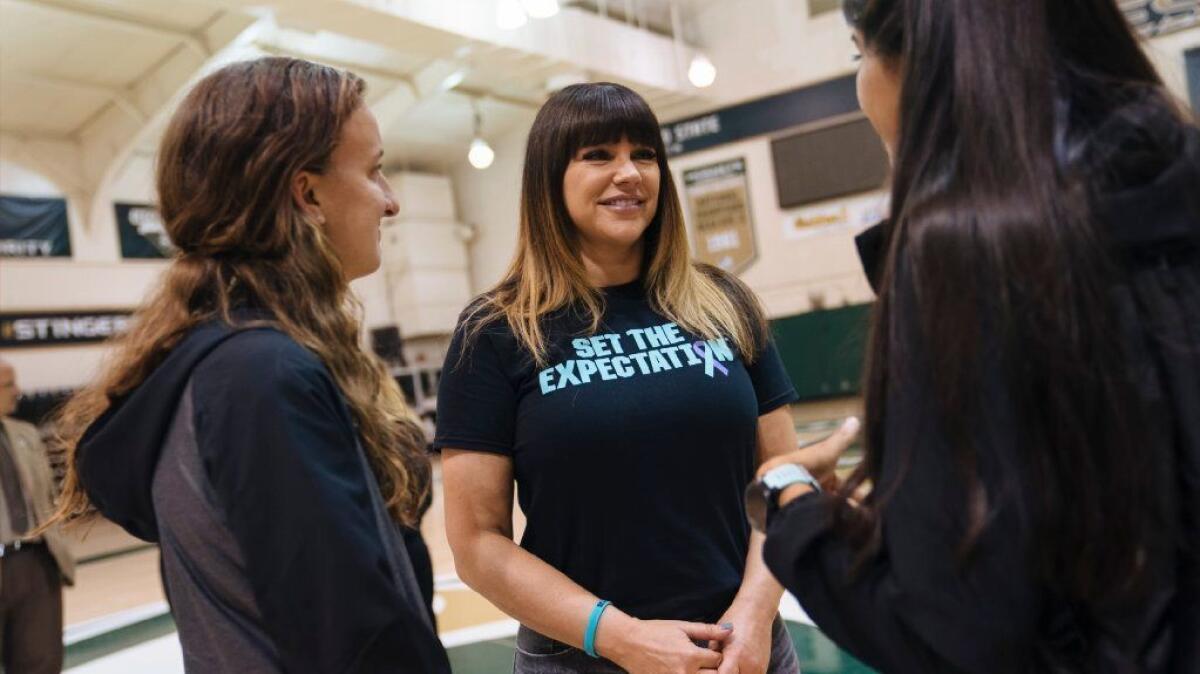 Athletes at Sacramento State University speak with Brenda Tracy on Oct. 17 after she spoke to student athletes about her sexual assault more than 20 years ago.