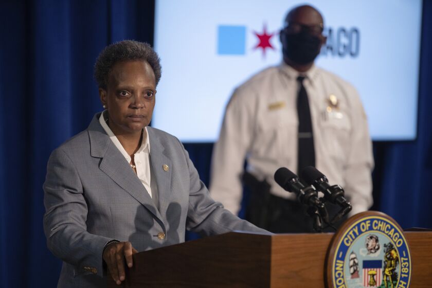 Mayor Lori Lightfoot speaks during a press conference at City Hall, in Chicago, Wednesday morning, July 22, 2020. Authorities say gunfire outside a funeral home on Chicago's South Side that wounded 15 people was part of an ongoing conflict involving the gang of the man being mourned. Police Superintendent David Brown says the person whose funeral people were attending Tuesday was killed in a drive-by shooting last week and that the person was believed to have been killed in retaliation for a previous shooting. (Pat Nabong/Chicago Sun-Times via AP)