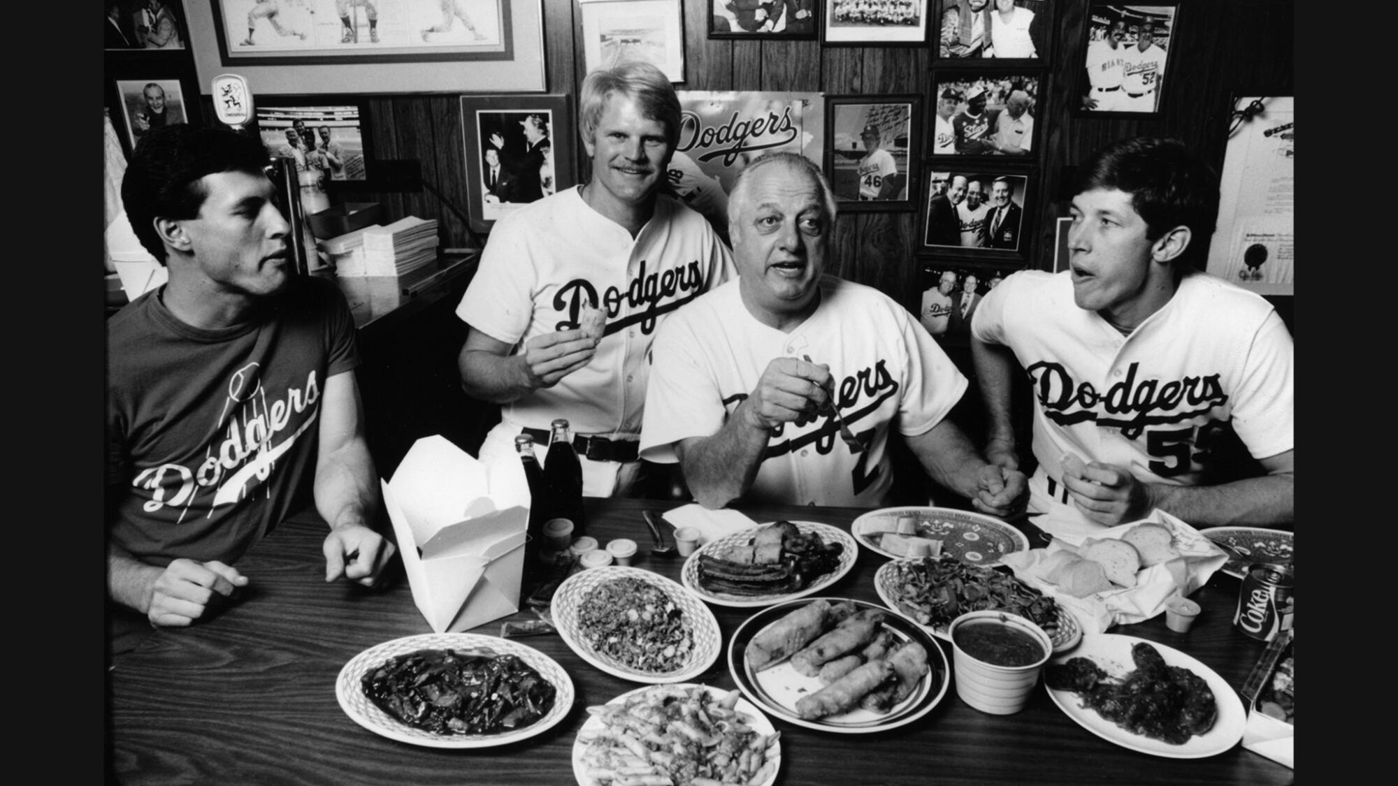 From left, Steve Sax, Jerry Reuss, Tommy Lasorda and Orel Hershiser share some Chinese and Italian food onOct. 3, 1985.