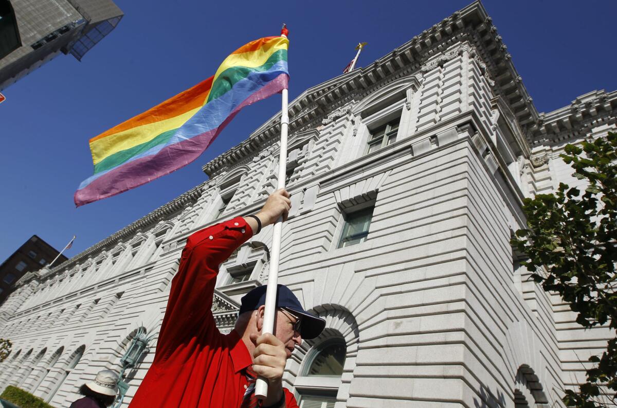 Political successes are among the reasons the gay community is more optimistic about the economy than the general public. Above, Ken Pierce waves a rainbow flag outside the courthouse where the U.S. 9th Circuit Court of Appeals heard arguments in 2011 in the fight over Proposition 8, a law forbidding gay marriage in California.