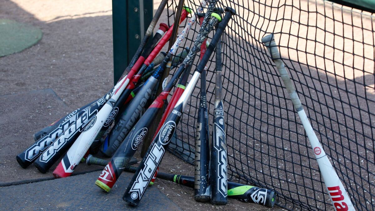 Composite bats at a recent game include the Louisville Slugger TPX Z1000, a 2012 model that’s been a hot topic lately.