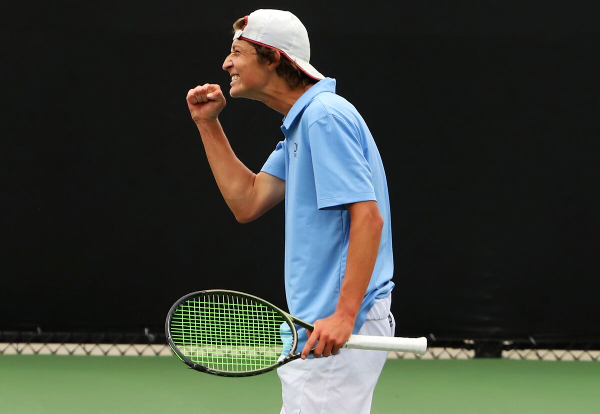 Corona del Mar High's Niels Hoffmann celebrates a point against Woodbridge High's Avery Tallakson on Wednesday.