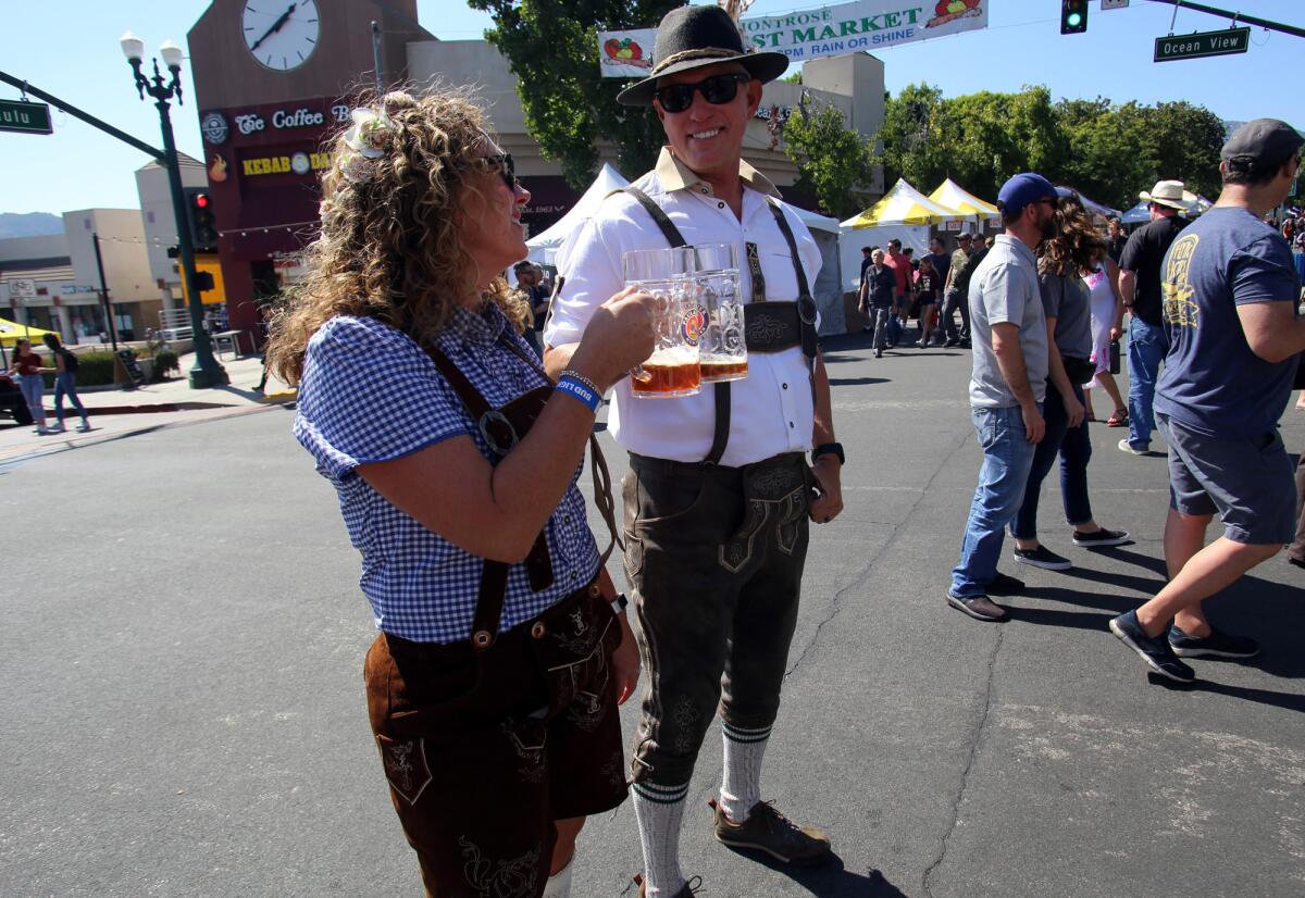 Jim & Lori Cassley, of San Fernando Valley, wearing German Lederhosen enjoy a German lager during the Montrose Oktoberfest