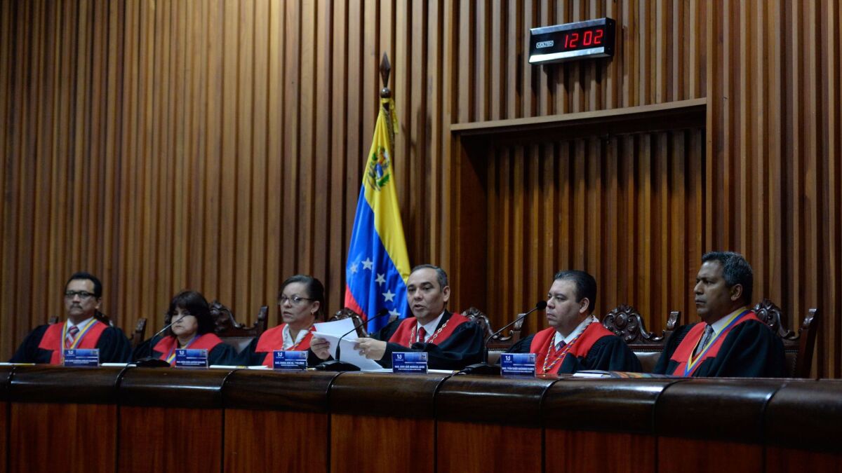 Venezuela's Supreme Court President Maikel Moreno speaks at court headquarters in Caracas on April 1, 2017. Venezuela's Supreme Court abandoned measures to seize power from the opposition-controlled legislature.