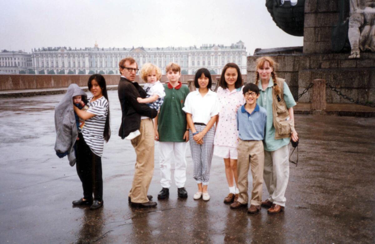 Woody Allen, Mia Farrow and family posing for a group portrait.