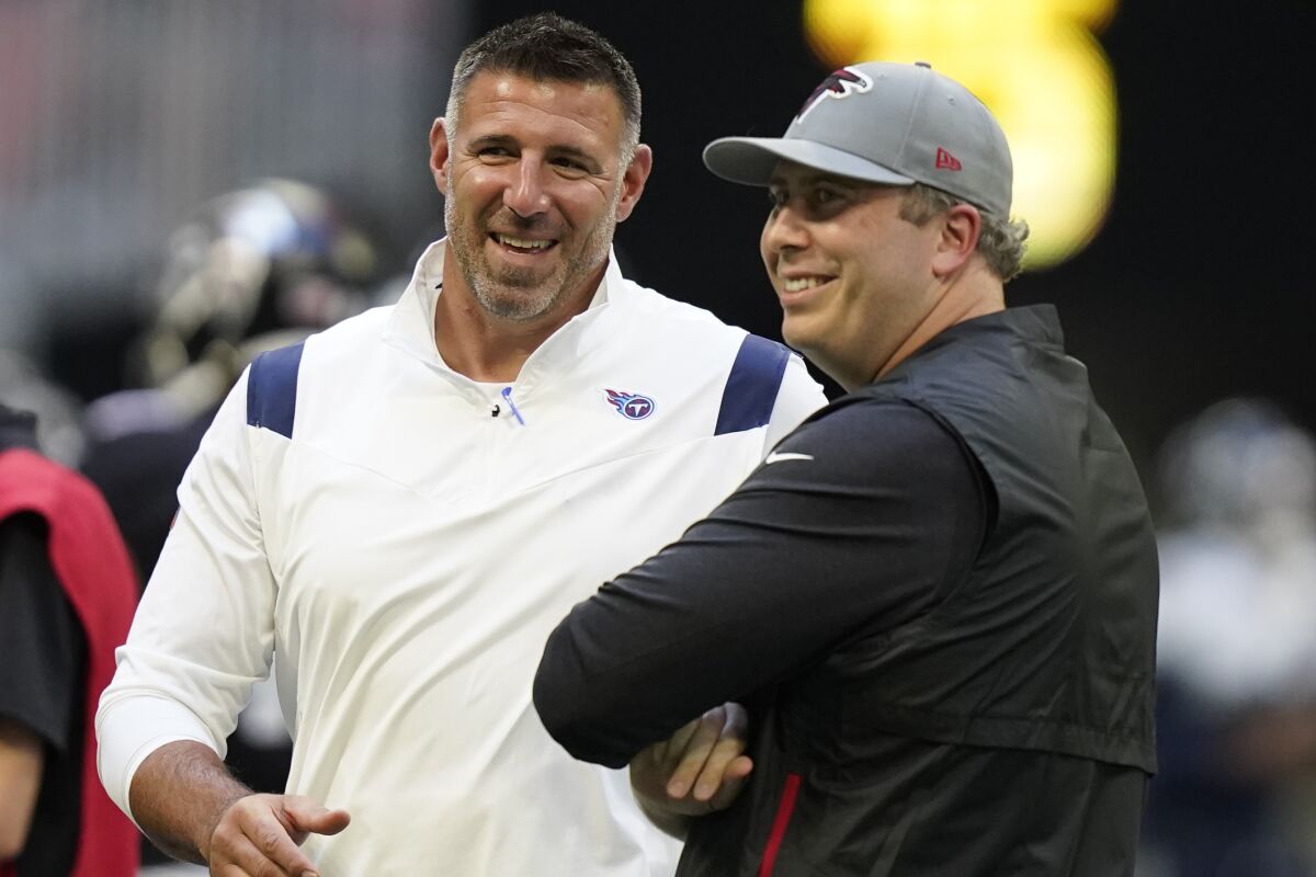 Tennessee Titans head coach Mike Vrabel, left, speaks with Atlanta Falcons head coach Arthur Smith before the first half of a preseason NFL football game, Friday, Aug. 13, 2021, in Atlanta. (AP Photo/Brynn Anderson)