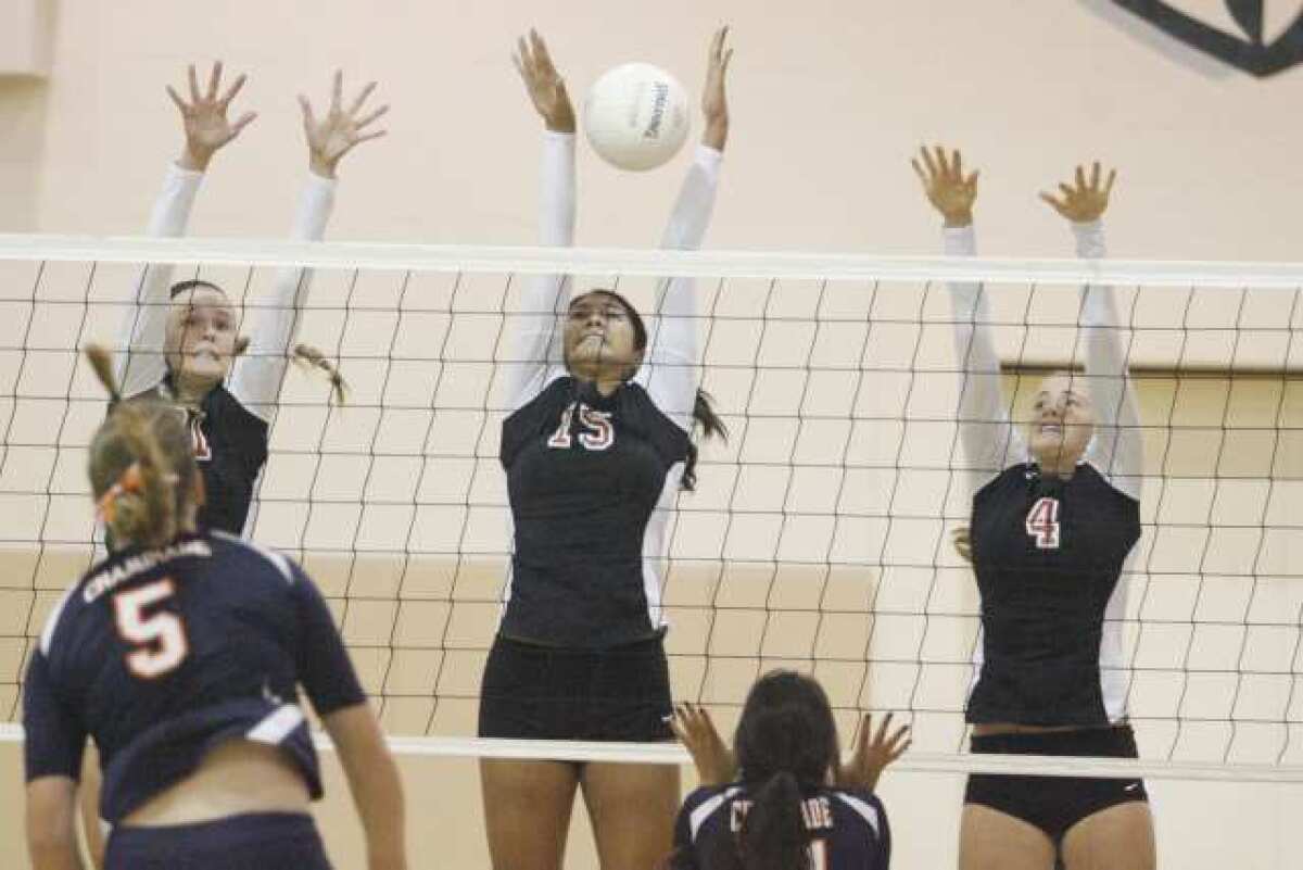 FSHA's Katie Conley, from left, Megan Bacall and Maddie Peterson block a spike against Chaminade.