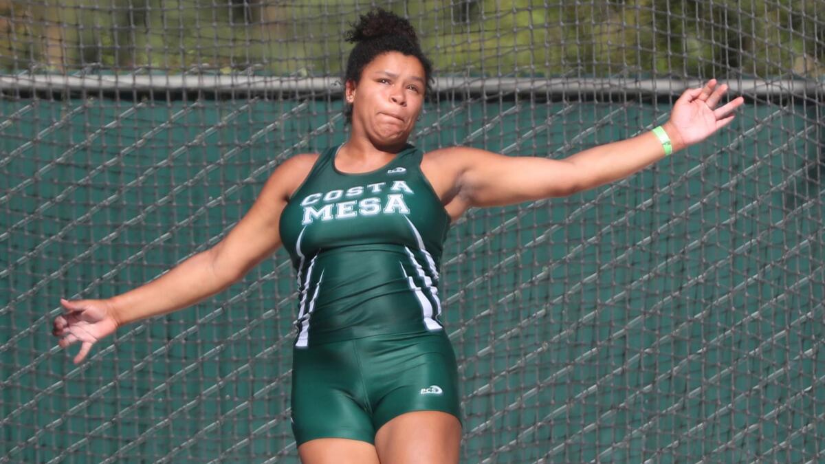 Costa Mesa High's Tayla Crenshaw looks at her throw in the girls’ discus at the 100th CIF State track & field championships at Buchanan High School Veterans Memorial Stadium in Clovis on Saturday.