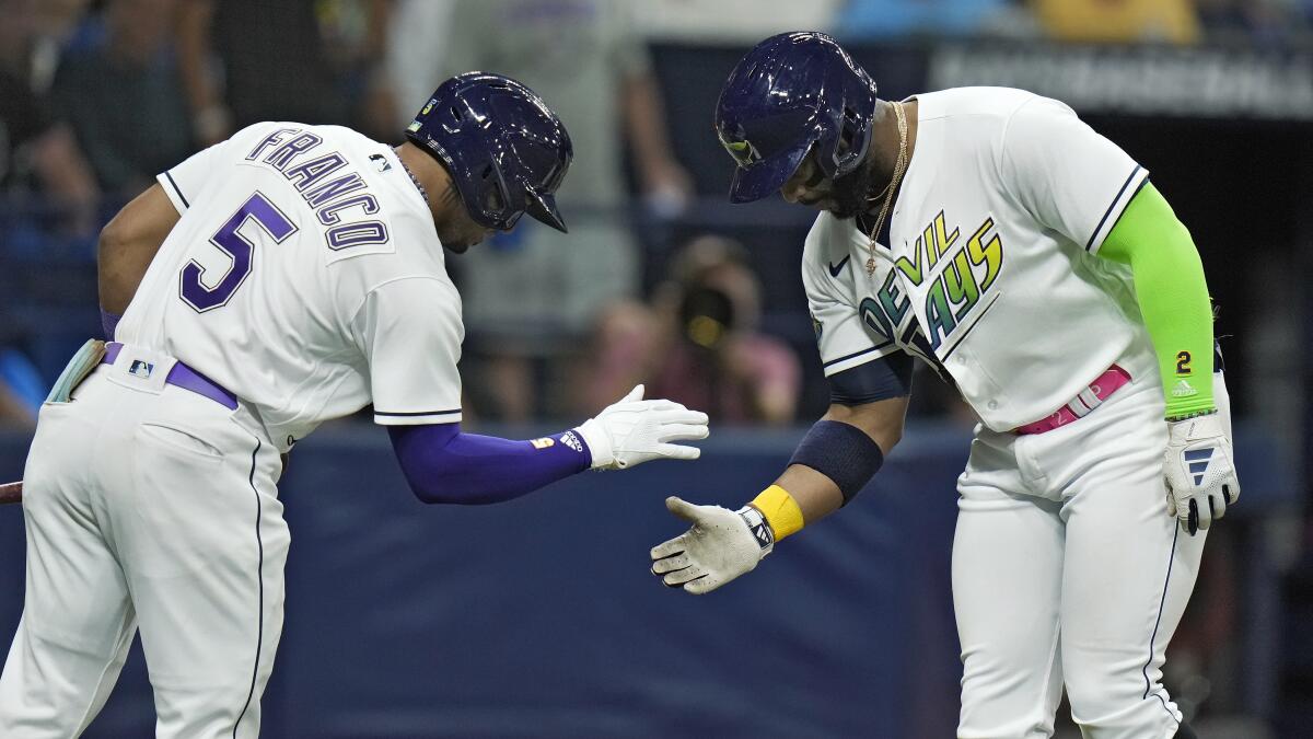Yandy Diaz, right, celebrates with Wander Franco after hitting a solo home run in the fourth inning.